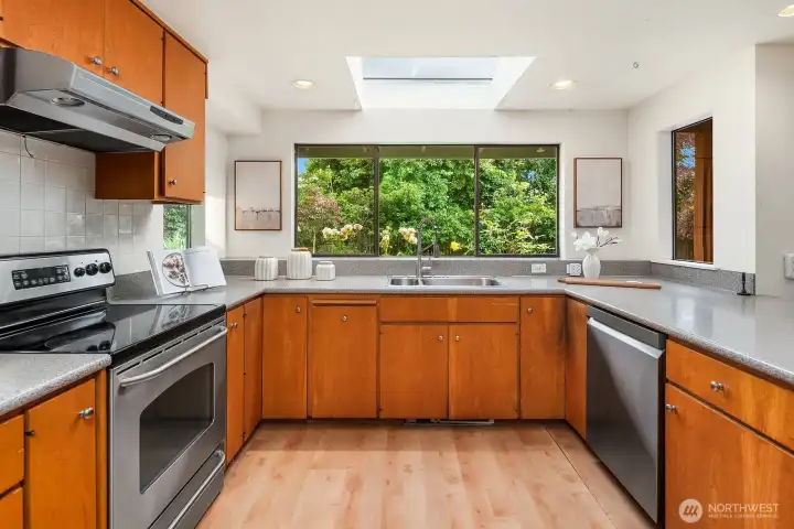 Stainless-steel appliances & hardwood-style flooring.