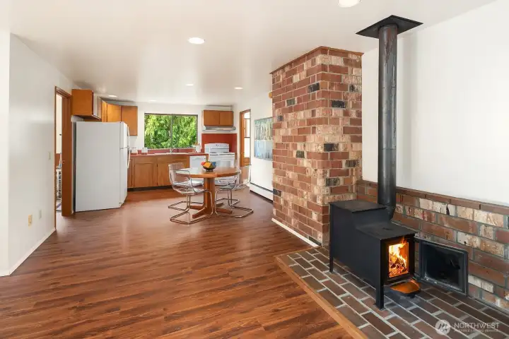 Cozy woodstove & open flow to the dining area & kitchen.
