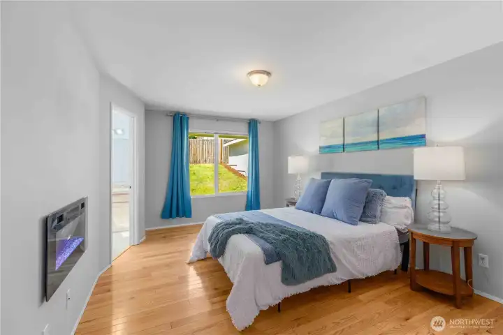 Primary bedroom with a cozy electric fireplace!
