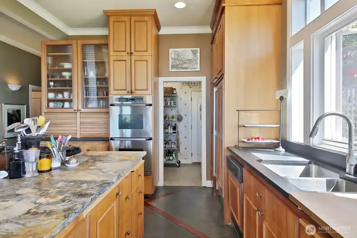There is a spacious pantry behind the kitchen. Go through the door and down the stairs to a perfect wine storage area! There is a spacious pantry behind the kitchen. Go through the door and down the stairs to a perfect wine storage area!