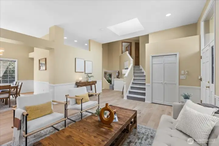 The living room opens to the dining room, with stairs leading to the home's 4 upstairs bedrooms.