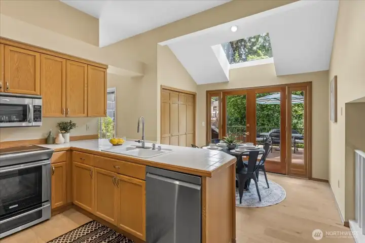 Vaulted ceilings, a skylight and french doors to the deck bring in plenty of natural light.