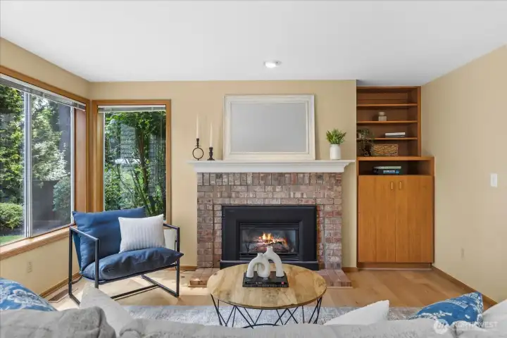 Cozy gas fireplace and built-ins create a warm and inviting gathering space.