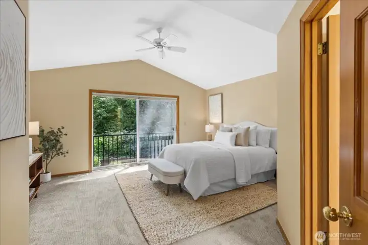 French doors open to a Juliet balcony, creating a bright and airy retreat in the primary bedroom.