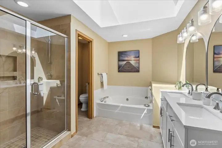 Primary bath has been refreshed with a new vanity, new mirrors, new lighting and new fixtures.