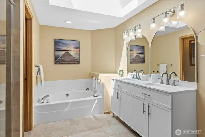 Skylights bring in plenty of natural light in the primary bath.