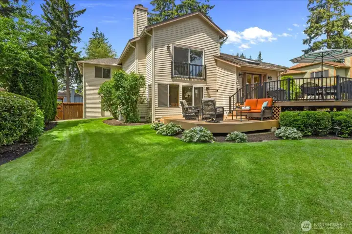 Multiple spaces to entertain and unwind, overlooking a beautifully landscaped backyard.