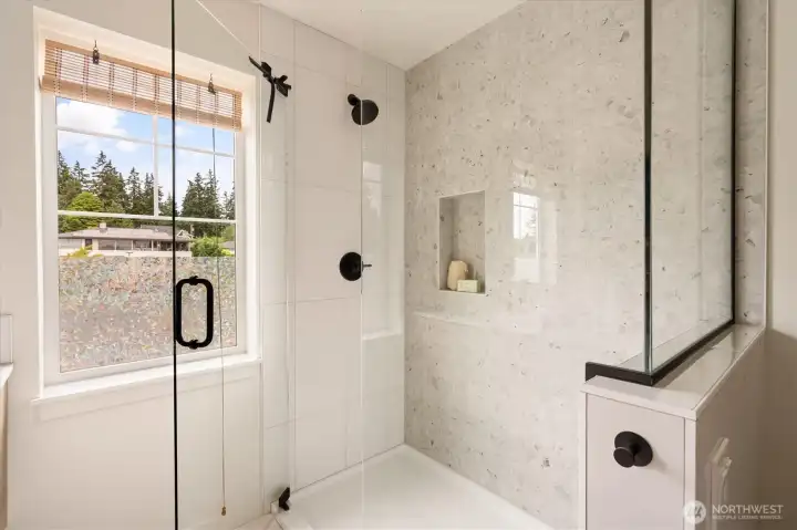 The shower has a combo over accent stone and white tile and with a glass surround is very nice. The shower has a combo over accent stone and white tile and with a glass surround is very nice.