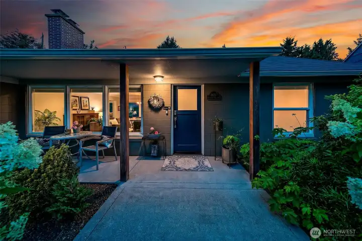 Thoughtfully renovated and expanded one-level home, warmly illuminated at twilight and framed by mature, professionally designed gardens. Thoughtfully renovated and expanded one-level home, warmly illuminated at twilight and framed by mature, professionally designed gardens.