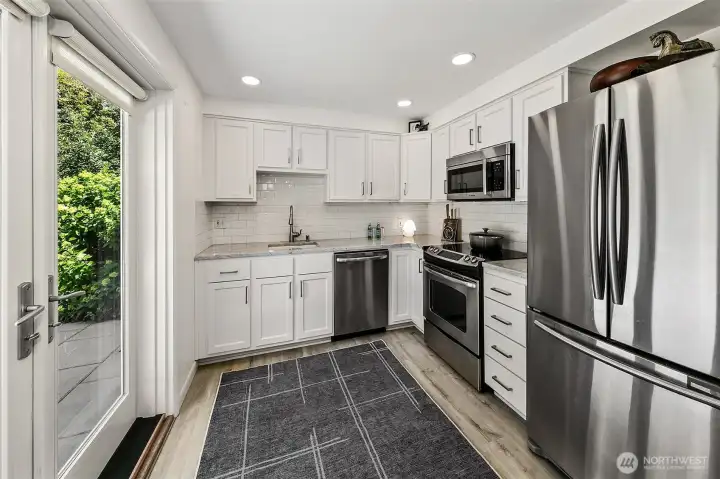 Kitchen with 2023 Northwest Cabinets cabinetry, marble countertops, subway tile backsplash, stainless-steel appliances and a convection oven. Kitchen with 2023 Northwest Cabinets cabinetry, marble countertops, subway tile backsplash, stainless-steel appliances and a convection oven.