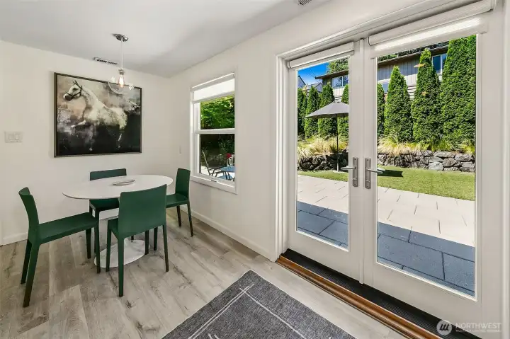 French doors and replacement windows fill the dining area with natural light while strengthening the connection to the garden. French doors and replacement windows fill the dining area with natural light while strengthening the connection to the garden.
