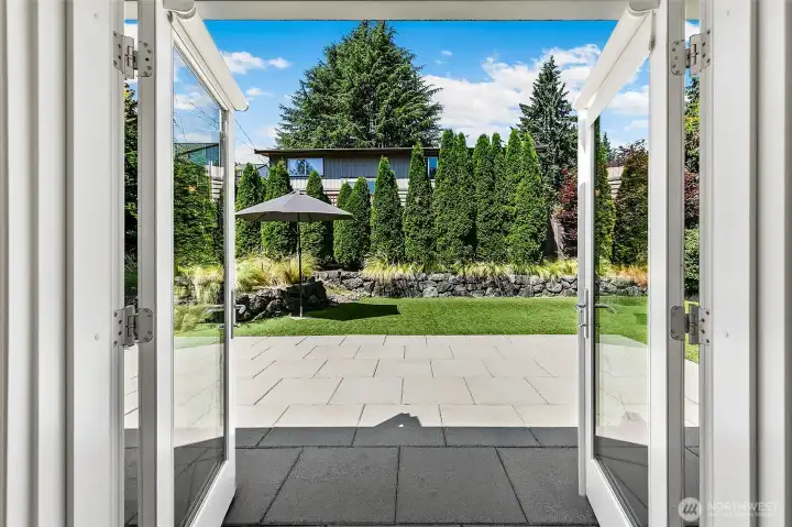 Open the doors to a large paver terrace and a professionally composed landscape designed as an extension of everyday living. Open the doors to a large paver terrace and a professionally composed landscape designed as an extension of everyday living.