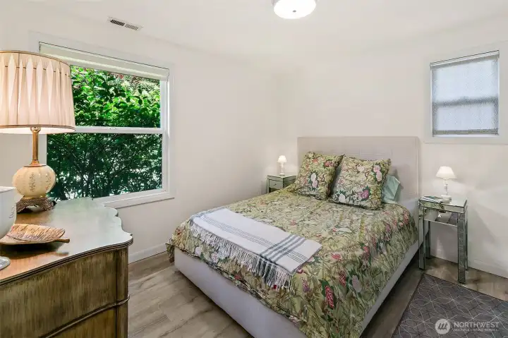 West bedroom with a double-door closet, motion-activated closet lighting, Shade Store roller blinds and mature hydrangeas outside. West bedroom with a double-door closet, motion-activated closet lighting, Shade Store roller blinds and mature hydrangeas outside.