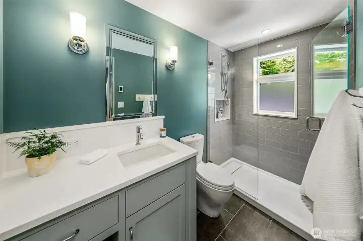South bathroom added during the 2018 renovation, featuring custom vanity cabinetry, quartz countertop and a programmable heated floor. South bathroom added during the 2018 renovation, featuring custom vanity cabinetry, quartz countertop and a programmable heated floor.