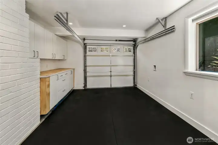 Fully insulated, heated and air-conditioned flex space with cabinetry, countertop workspace, rubber flooring and preserved garage access. Fully insulated, heated and air-conditioned flex space with cabinetry, countertop workspace, rubber flooring and preserved garage access.