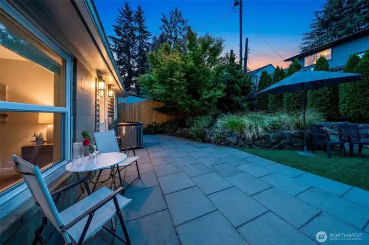 The large paver terrace offers generous space for outdoor dining and lounging, with integrated landscape lighting extending its evening use. The large paver terrace offers generous space for outdoor dining and lounging, with integrated landscape lighting extending its evening use.