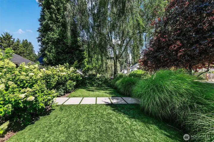 Low-maintenance turf, established trees and carefully layered borders create a peaceful garden with structure, screening and year-round appeal. Low-maintenance turf, established trees and carefully layered borders create a peaceful garden with structure, screening and year-round appeal.