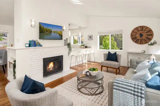 Family room just off the kitchen has a charming fireplace and is light and bright all year!