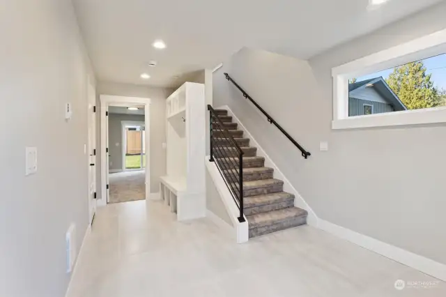 Built-in Coat rack & bench. Garage to the left and through door Bdrm with ensuite and slider to back yard.