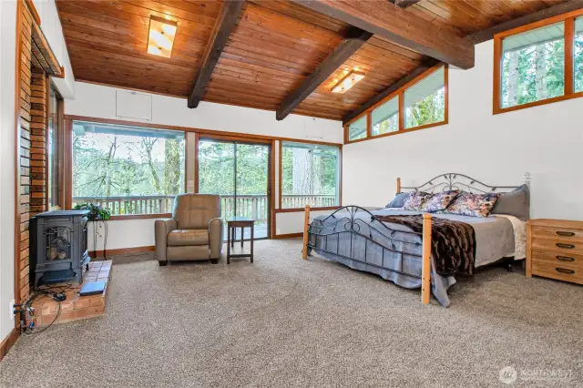 Primary bedroom is quite large, tons of window bring nature indoors.....