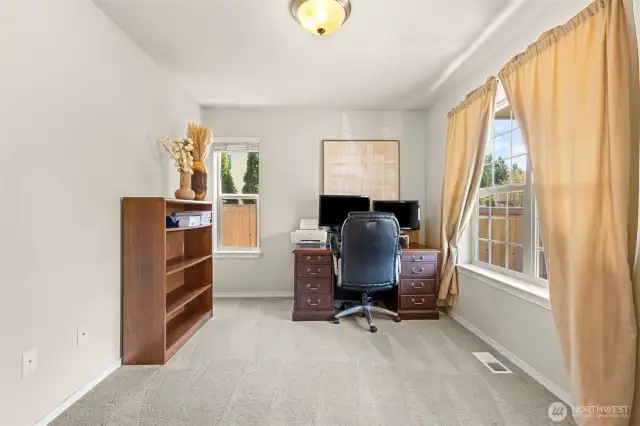 Den/ office with double French doors to right of entry way.