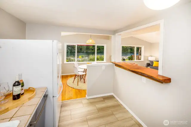 Pour a glass, prep a snack, and stay part of the conversation—this smartly designed kitchen keeps the view (and the vibe) flowing. A custom live-edge bar adds rustic elegance and functional charm, making cooking for guests or family both easy and engaging.