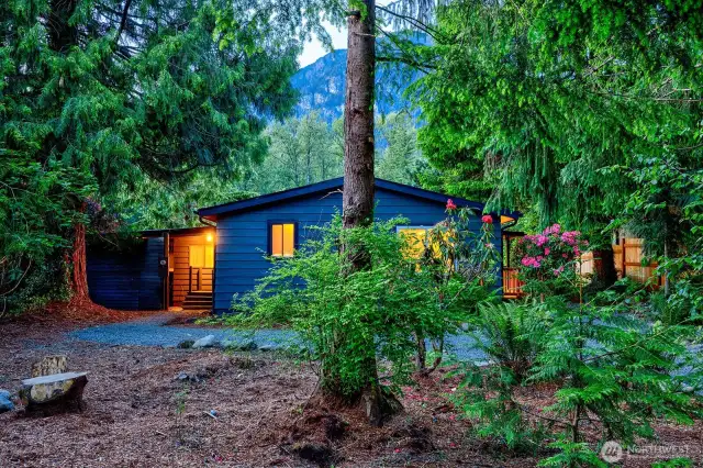 Tucked among tall cedars and flowering rhododendrons, the circular drive welcomes with room for 6 vehicles—perfect for guest arrivals, boat trailers, RVs, or ATV haulers. Whether you're hosting a crew or staging weekend adventures, the layout delivers both function and forested charm.