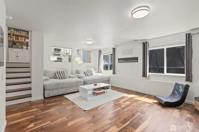 Beautiful and spacious family room with peek-a-boo view into the kitchen on the floor above.