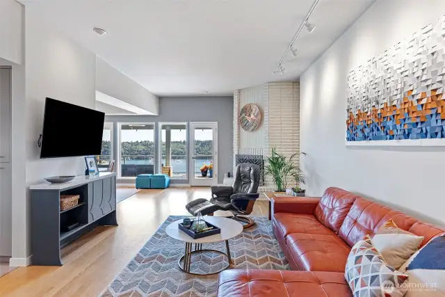 Refinished hardwood oak floors cover much of the main living spaces. The first of three wood-burning fireplaces anchors the room.