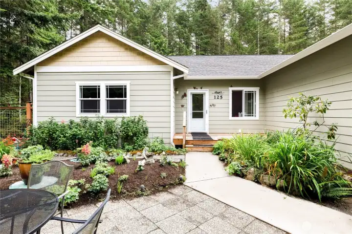 Front garden has been meticulously cared for, and is full of spring-blooming bulbs and perennials, making for a bright and colorful garden, perfect for morning coffee or entertaining guests.
