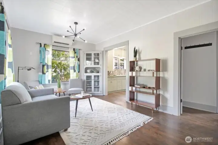 Spacious living room with original fir floors and high ceilings.
