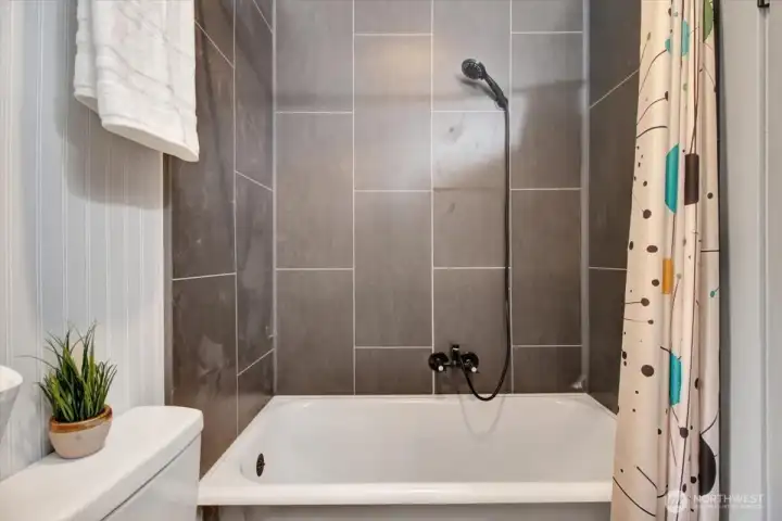 Cast iron tub with new tile work.