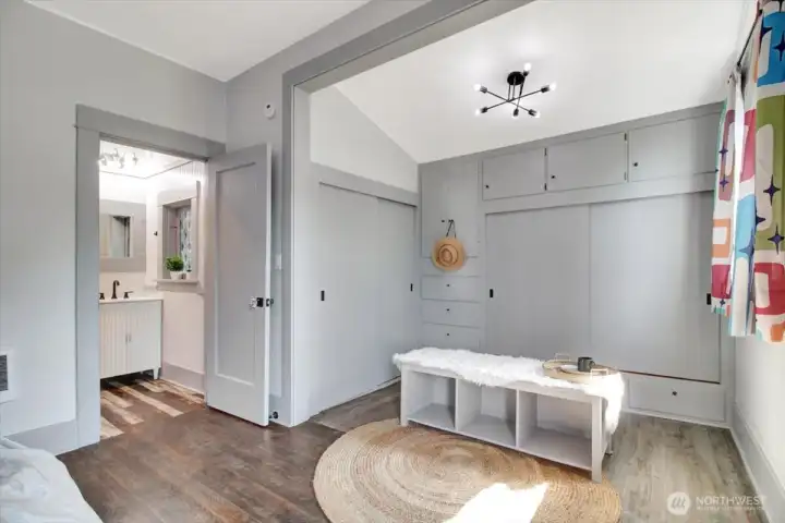 Large alcove off the primary bedroom has 2 closets and built in cabinets/drawers for storage.  Bedroom opens to bathroom.