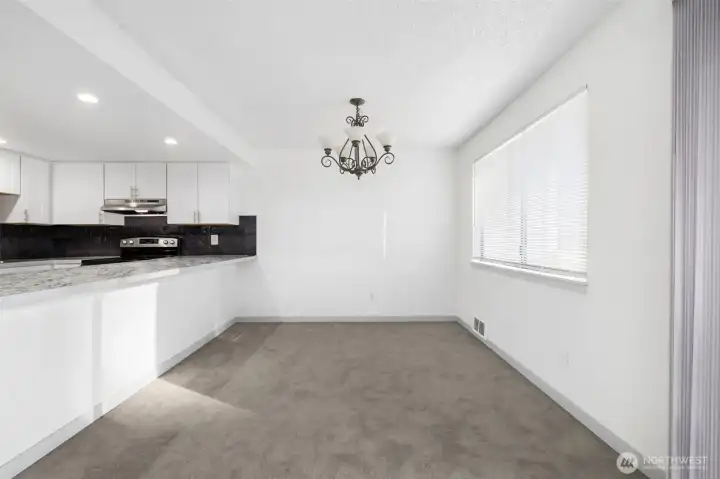 Dine in style with a view of the updated kitchen. New cabinets and appliances are ready for you.