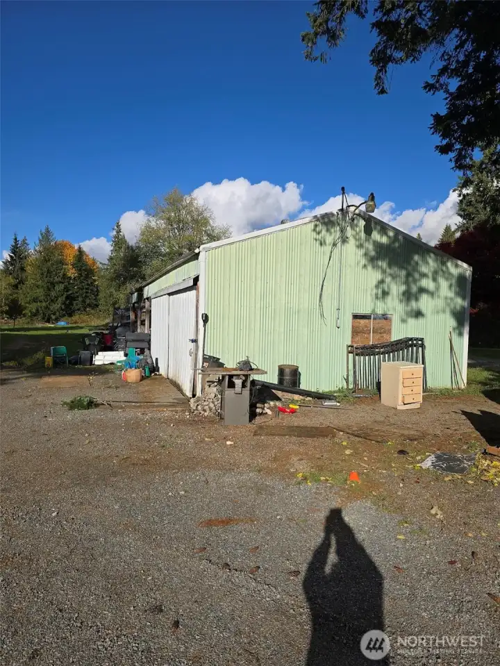 Large storage buidling with covered area for up to 3 vehicles.