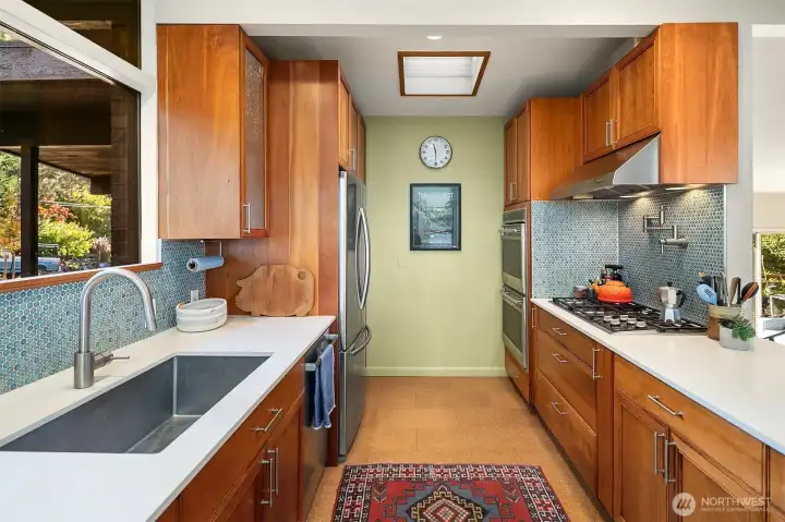 The kitchen features a Wolf electric double oven and 5 burner gas stove, plus a pot filler for pasta!