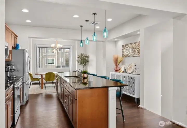 Expansive island with bar seating creates a central gathering point