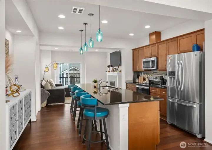 Modern pendant lighting adds a stylish touch above the large island