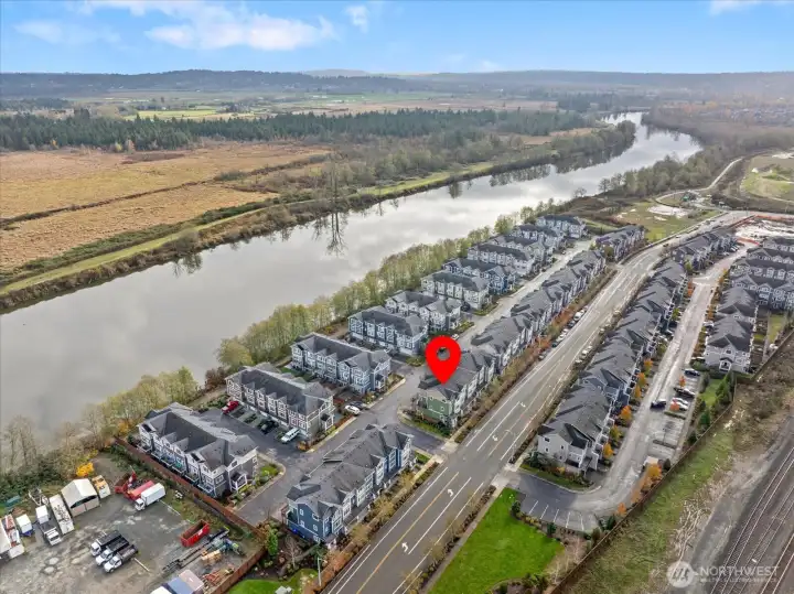 Sweeping overhead view capturing the winding Snohomish River and the home’s convenient placement near neighborhood roads, trails, and community access points.