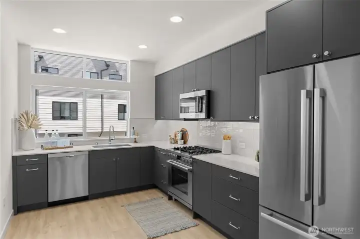 Stainless appliances glisten against a backdrop of modern cabinetry offering both style and function.