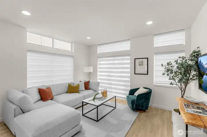 Bright corner living space framed by large windows creates an ideal spot to entertain.