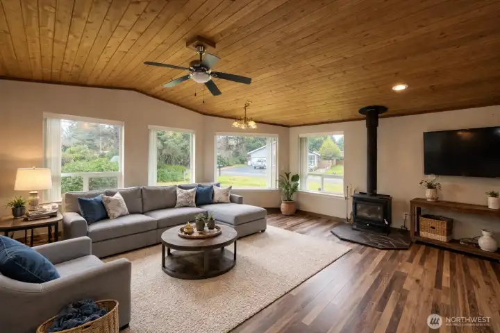 Large great room that includes a wood fireplace.