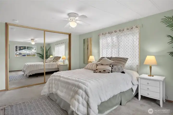 The bedroom is large, and the mirrored closet makes it look even larger.