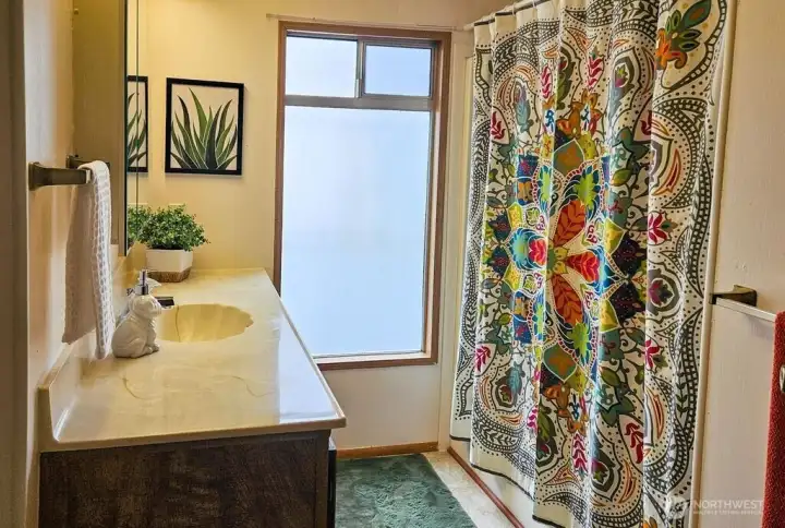 Bright, full bath between bedroom #1 and #2.