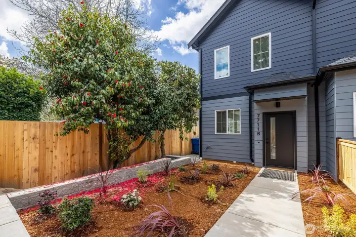 Fully fenced front yard with gracious entry.