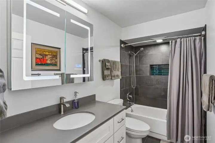 Updated bath with designer tile, quartz counter and heated floors. Updated bath with designer tile, quartz counter and heated floors.