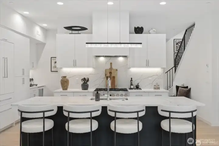 Chef’s kitchen with clean lines, premium finishes, and generous seating.