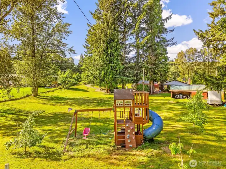 Fenced pasture with wood play set