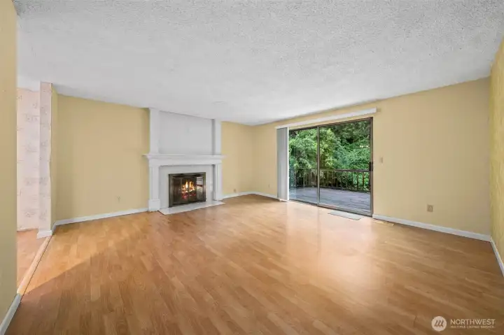 Fireplace anchors the living room and slider opens onto large deck. Fireplace anchors the living room and slider opens onto large deck.