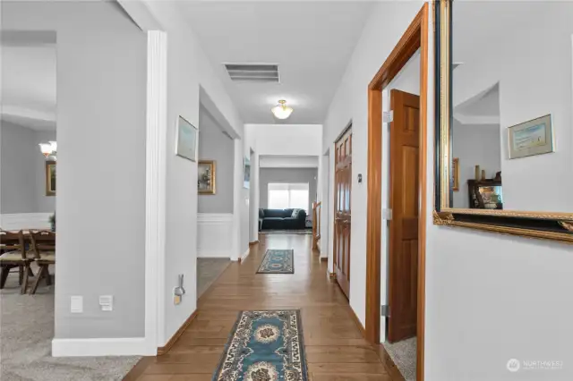 Another shot of the hallway looking from the front door. The Office is on the right thru the double doors, and to the left the living room and dining room, straight ahead is the family room.